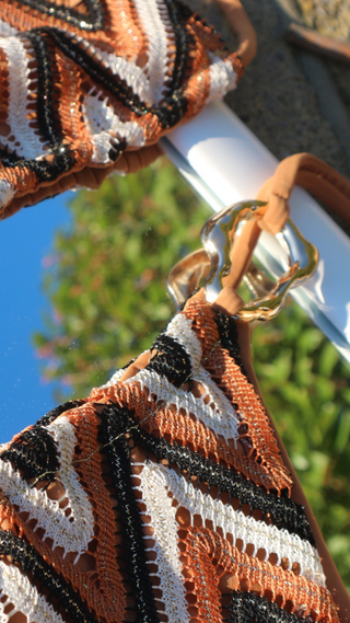 Tan zigzag bikini set with adjustable ties and a textured woven fabric.