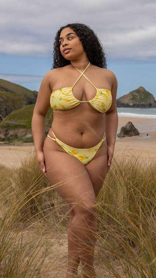 Double layered lemon print bikini set with adjustable halterneck top and minimal bottom.