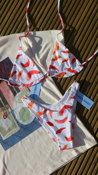 Picante bikini set flatlay made from chilli-printed fabric by Ashlea Baker Swimwear